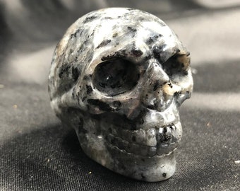 Crystal skull. Skull carved with grey labradorite hand. 5cm in length.