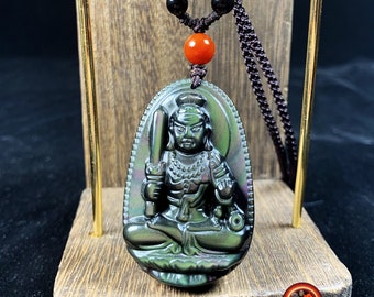 Pendant, Buddha, Acala. Buddhist amulet in obsidian celeste eye. obsidian natural celeste eye of mexico. Cord, jade.