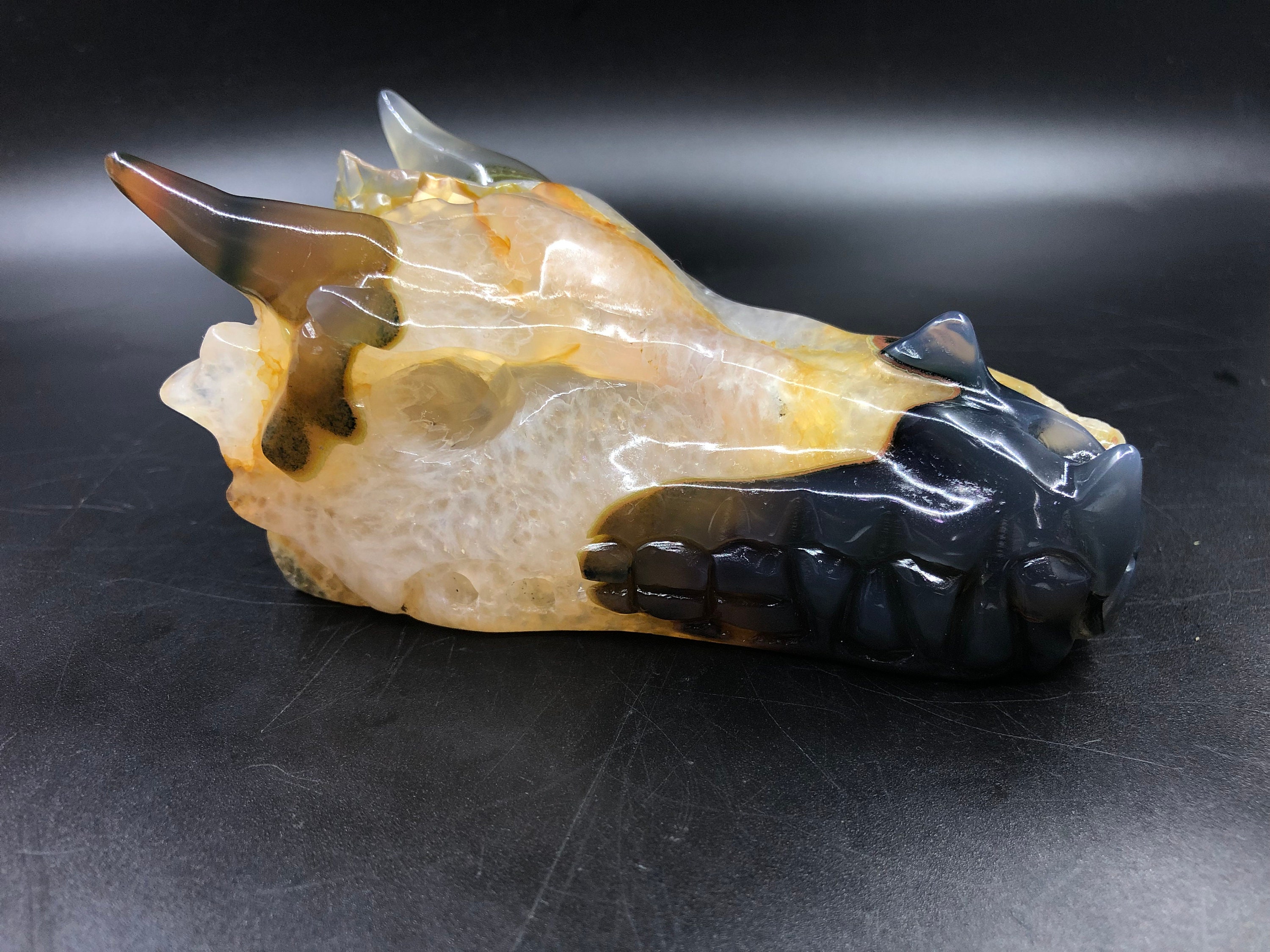 crystal dragon skull. Hand-carved dragon in a quartz geode on rock ...