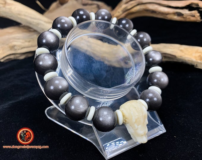 silver obsidian bracelet, Dragon head made of buffalo bone. obsidian of exceptional quality. Mounted on resistant cord.