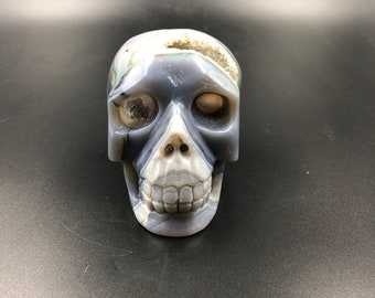 Crystal skull. hand-carved skull. Quartz geode on agate gangue. Unique piece