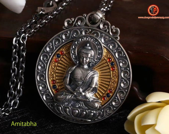 Pendant, Buddhist protective amulet, Amitabha Buddha. revolving wheel on the back of the Buddha, Tibetan mantra on the back of the amulet.