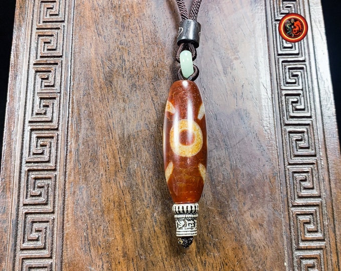 Authentic DZI, sacred Tibetan agate with two eyes "stability and balance". Cord embellished with Qinghai nephrite jade.
