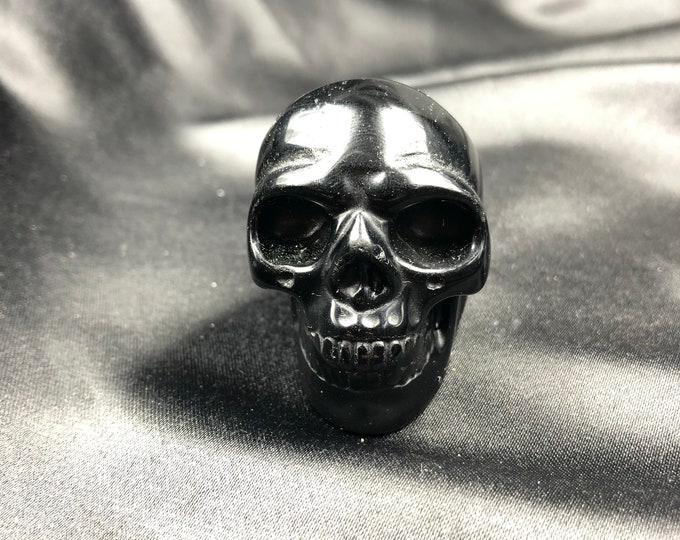 Crystal skull. Skull carved with black obsidian hand. 5cm in length.