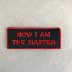 May include: Red embroidered patch with black background and the text "NOW I AM THE MASTER" in red.