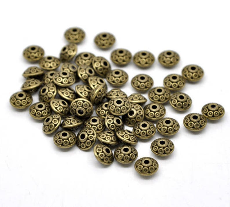 Infill beads flying saucers in bronze colored metal