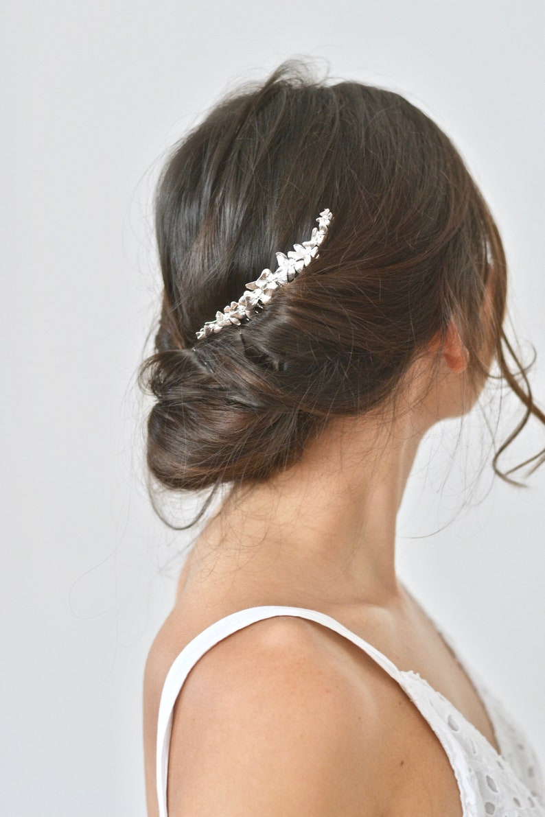 Applying hair gold fairy antique and delicate romantic boho wedding jewelry. Half Crown flowers gold leaves bridal comb