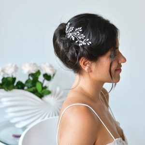 Wedding hair jewelry. Leaves, branch, tiara, crown, vine crystals, rhinestones, silver bridal hairstyle application