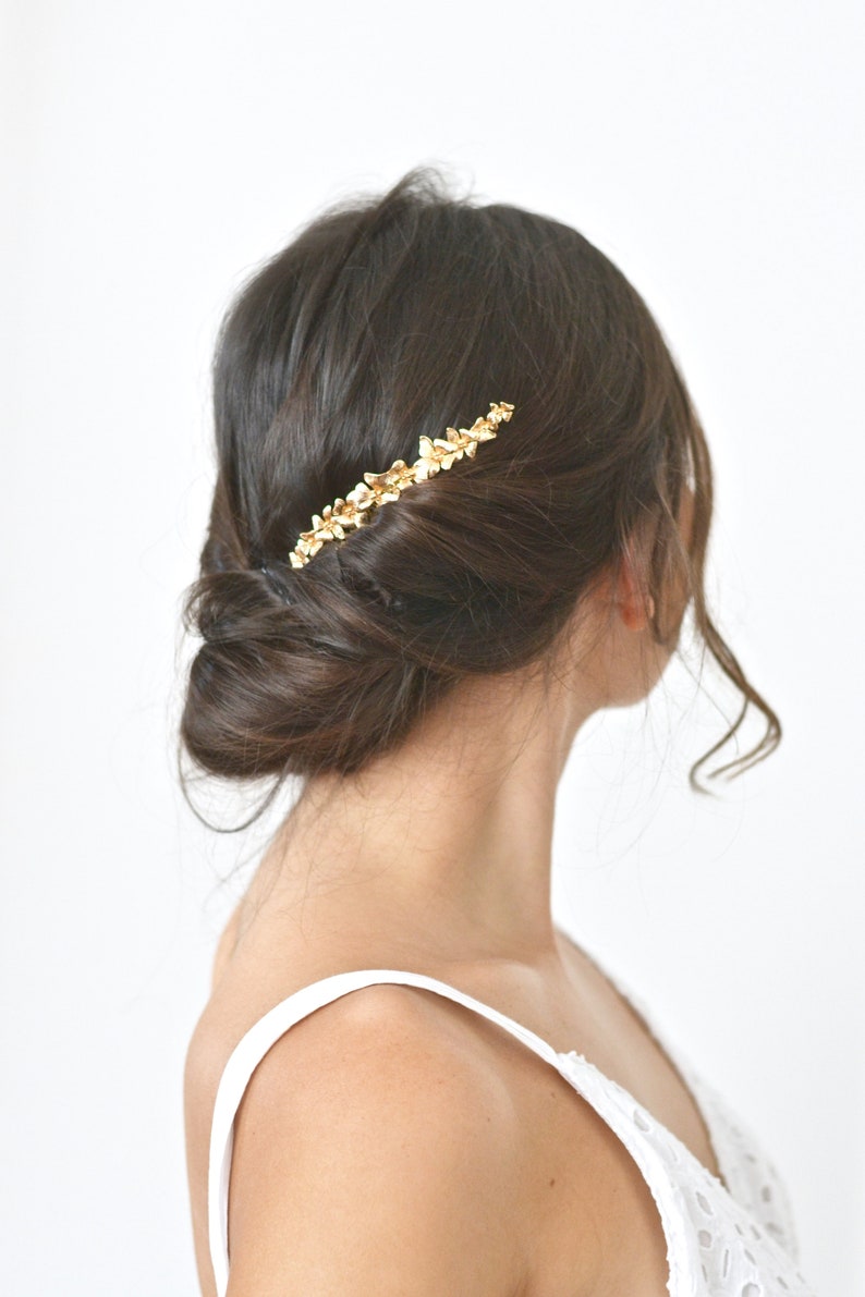 Applying hair gold fairy antique and delicate romantic boho wedding jewelry. Half Crown flowers gold leaves bridal comb