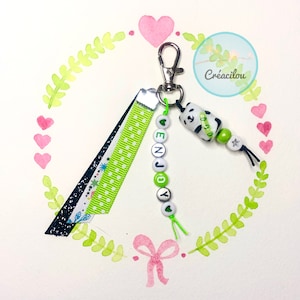Porte-clés, bijou de sac ou gri-gri PANDA - Inscription « ENJOY » - Perles porcelaine, lettres et rubans - Coloris vert, blanc, argent, noir