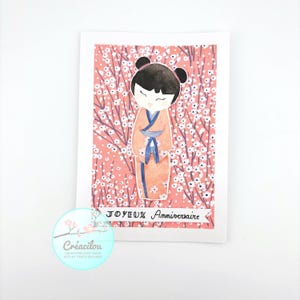 CARTE POUPEE KOKESHI Japonaise et Fleurs - Anniversaire -Texte "Joyeux anniversaire" - Aquarelle et  Papier japonais - Tons rose, bleu, noir