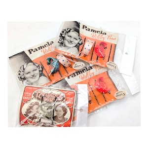 Hårspännen och hårnålar i Lucite från 1940-talet i originalförpackning