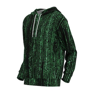 以下が含まれることがあります： 緑色のデジタルレインパターンが施された黒いパーカー。フード付きスウェットシャツには、ドローストリングとカンガルーポケットが付いています。デザインは、黒い背景に緑色の文字が繰り返されるパターンです。