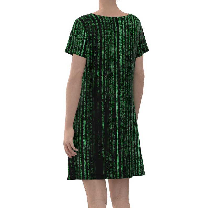 May include: A black and green short-sleeved dress with a pattern of green code on a black background.