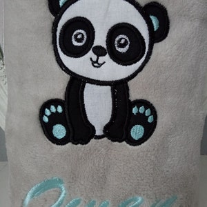 May include: A gray plush blanket with an embroidered panda bear and the name "Owen" in light blue thread.