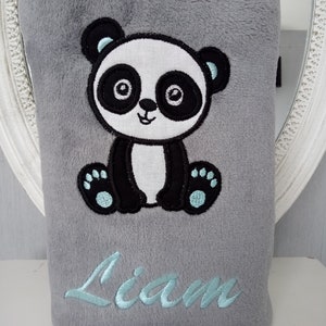May include: Gray plush blanket with an embroidered panda bear and the name "Liam" in light blue thread.