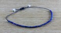 Adjustable bracelet with 50 small lapis-lazuli - blue thread product logo