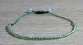 Peridot Bracelet with 50 small gemstones - Green nylon thread - August birthstone - Minimalistic and adjustable - Gift idea for her product logo