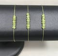 Bracelet with 7 small Peridots - different thread colours available, August birthstone, minimalistic and adjustable bracelet, green gemstone product logo