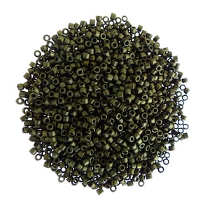 Peut inclure: Un grand tas de petites perles rondes de couleur vert foncé. Les perles sont en métal et ont une finition légèrement brillante.