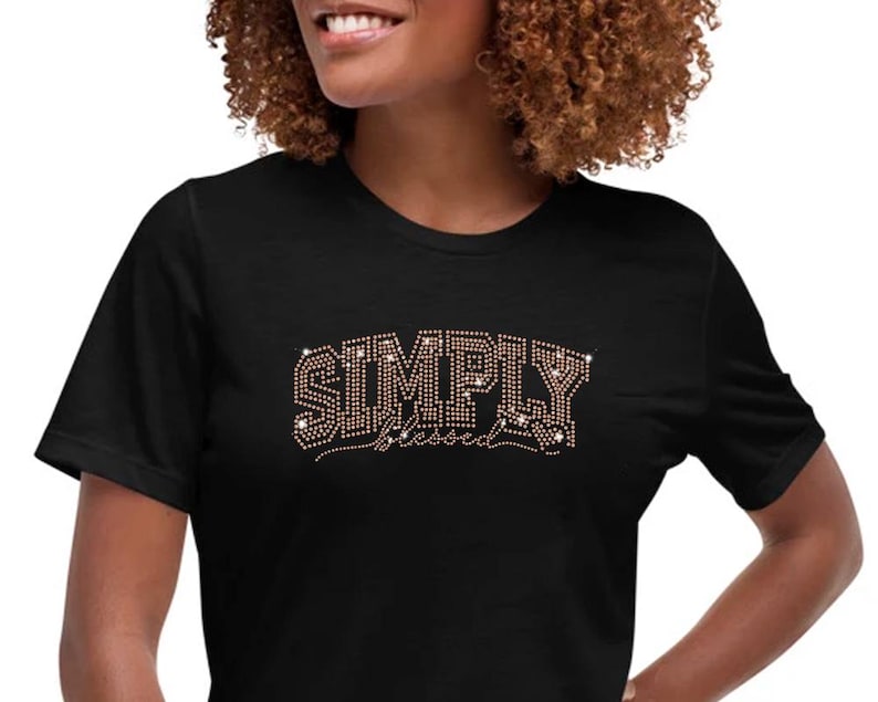 May include: Black t-shirt with the words "SIMPLY Blessed" in rhinestones.