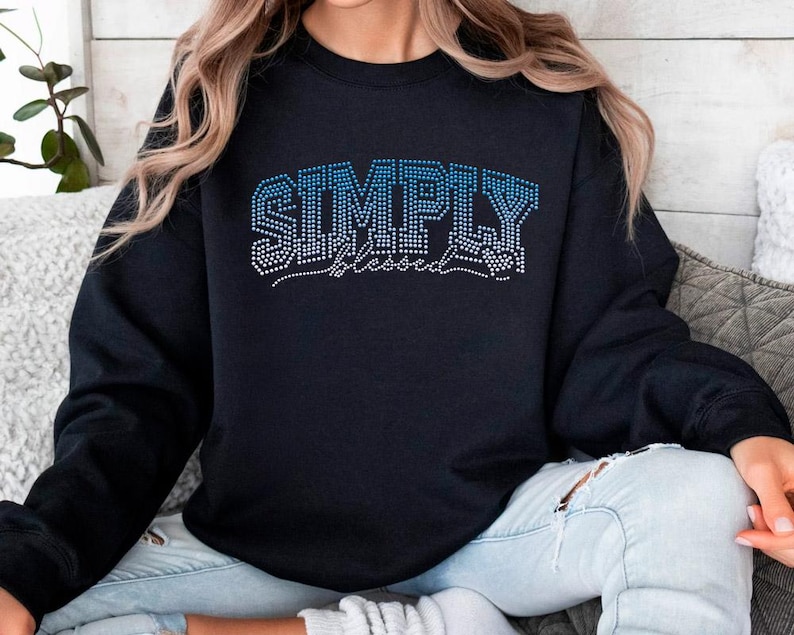 May include: Black sweatshirt with the text "SIMPLY blessed" in blue rhinestones.