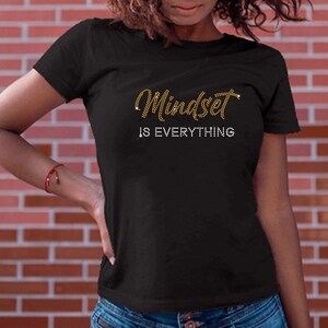 May include: Black t-shirt with gold glitter lettering that reads "Mindset is Everything".