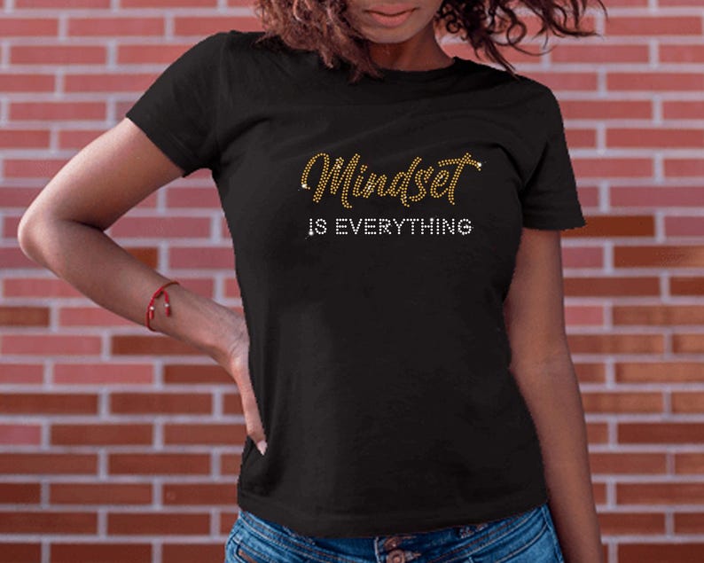 May include: Black t-shirt with gold glitter lettering that reads "Mindset is Everything".