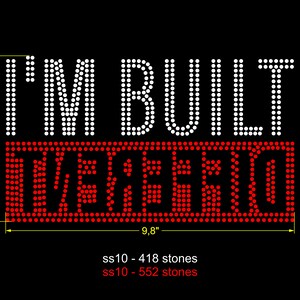 May include: White rhinestone design that reads "I'M BUILT DIFFERENT" with a red rhinestone rectangle underneath. The design is approximately 5.6 inches tall and 9.8 inches wide.