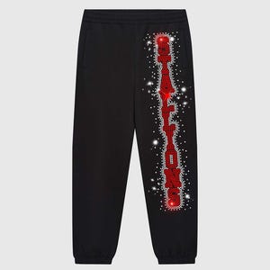 May include: Black sweatpants featuring the word "STALLION" vertically in red rhinestones down the left leg. White rhinestones are scattered around the word. The trousers have pockets and a drawstring waist.