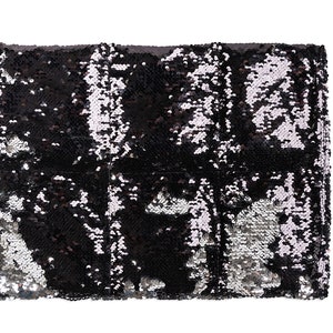 May include: A black and silver sequined clutch purse. The sequins are arranged in a pattern that creates a shimmering effect.