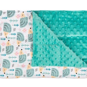 a baby blanket with a green and white design