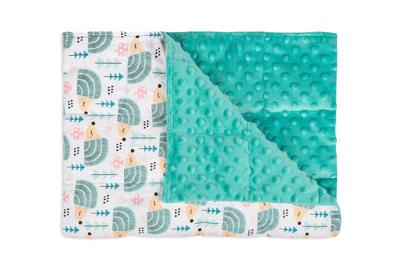 a baby blanket with a green and white design