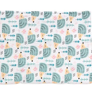 a white blanket with a blue and yellow pattern