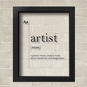 May include: A black framed print with the word "artist" in large font and a definition below. The definition reads "a person whose creative work shows sensitivity and imagination".