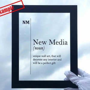 May include: Black framed wall art with the text "NM New Media (noun) unique wall art, that will decorate any interior and will be a perfect gift"