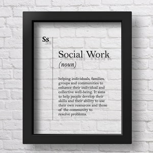 May include: Black framed print with a white background and black text defining "Social Work" as a noun. The definition explains that social work is about helping individuals, families, groups, and communities to enhance their well-being.