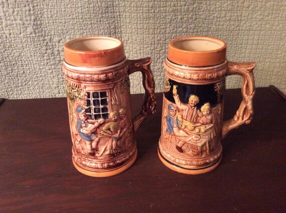 Vintage Enesco Coat of arms Beer Stein still has original sticker on the botton.Mug holds 14 oz made in Japan 5 1/8 tall 2 1/2 at the mouth.