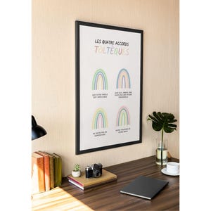 May include: A black framed print with a white background and rainbow illustrations. The text on the print reads "Les Quatre Accords Tolteques". The text below each rainbow reads "Que votre parole soit impeccable", "Que quoi que arrive, faites-en une affaire personnelle", "Ne faites pas de suppositions", and "Faites toujours de votre mieux".