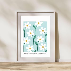 May include: A white framed print with a light blue background and a repeating pattern of white daisies with yellow centers and green stems. The text "FAITES TOUJOURS DE VOTRE MIEUX" is at the bottom of the print.