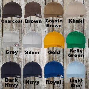 A collection of custom Flexfit hats. The collection includes colors: Black, charcoal, white, brown, purple, gold, grey, spruce, navy, royal, light blue, Kelly green, silver, olive, stone, khaki, coyote brown and dark navy.