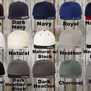 A collection of custom Flexfit hats. The collection includes colors: Black, charcoal, white, brown, purple, gold, grey, spruce, navy, royal, light blue, Kelly green, silver, olive, stone, khaki, coyote brown and dark navy.