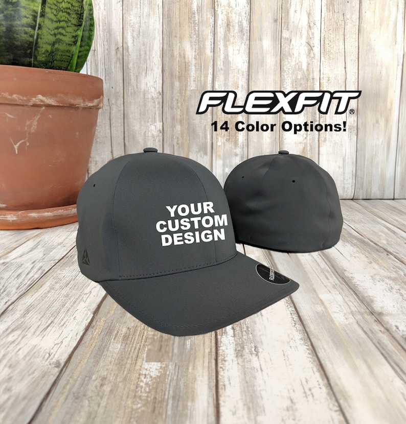May include: A dark grey Flexfit baseball cap with a white embroidered design that says "YOUR CUSTOM DESIGN".