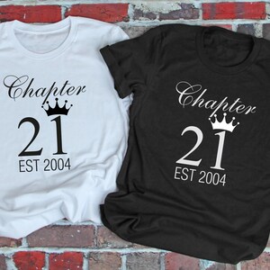 May include: Two t-shirts, one white and one black, with the text "Chapter 21 EST 2004" and a crown above the number 21.