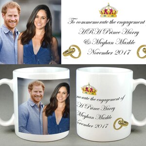 May include: White ceramic mug featuring a photograph of Prince Harry and Meghan Markle. The mug also includes the text "To commemorate the engagement of HRH Prince Harry & Meghan Markle November 2017".