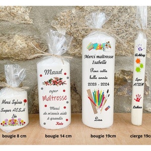 May include: Four white candles with personalized messages. The candles are decorated with colorful flowers, school supplies, and handprints. The candles are 8 cm, 14 cm, 19 cm, and 19 cm in length.