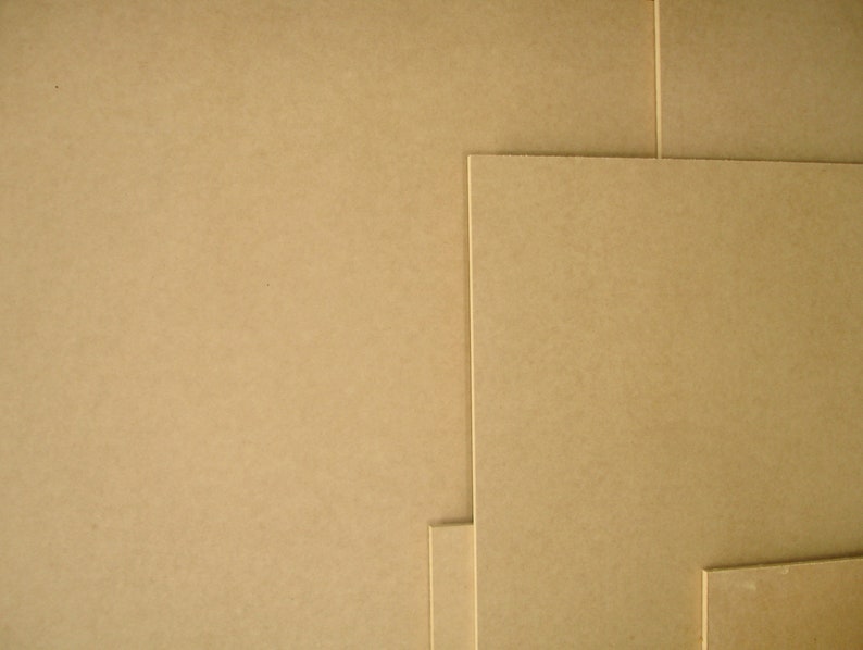 May include: A collection of beige-colored, rectangular sheets of paper or cardboard, arranged in a layered composition. The sheets vary in size and are stacked together, creating a textured surface. The image showcases the material's color and texture.