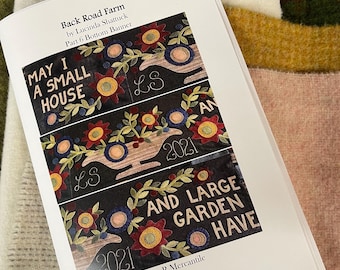 May include: A printed pattern booklet titled Back Road Farm by Lucinda Shattuck, Part 6 Bottom Banner. The cover displays three horizontal sections of dark fabric featuring embroidered flowers, vines, and the text MAY I A SMALL HOUSE AND LARGE GARDEN HAVE, LS, and 2021. The bottom includes the Triple R Mercantile logo.