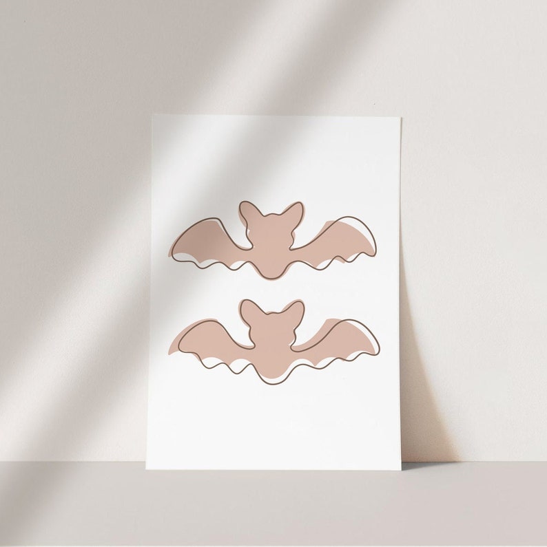 Three Halloween prints. The first print features two blush colored bats, the second print is a blush colored jack’o-lantern and the third print is two adorable blush colored ghosts.