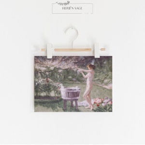 A vintage painting with pinks and green hues of a woman bathing in a meadow.